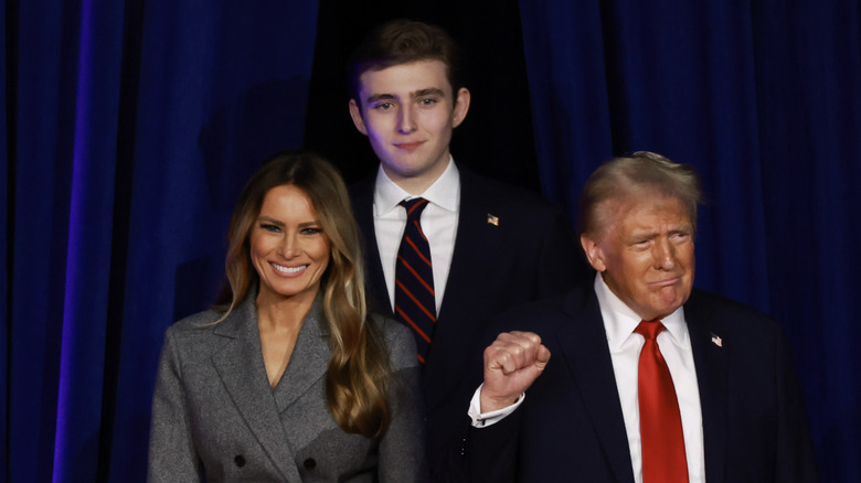 Barron Trump stands behind Donald and Melania Trump during campaign event