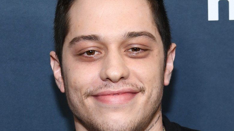 Pete Davidson smiling on the Hulu red carpet