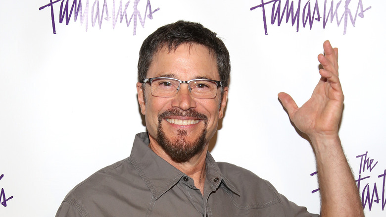 Peter Reckell wearing glasses, posing at event