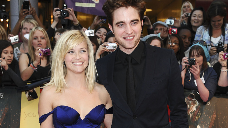 Reese Witherspoon and Robert Pattinson smiling on the red carpet