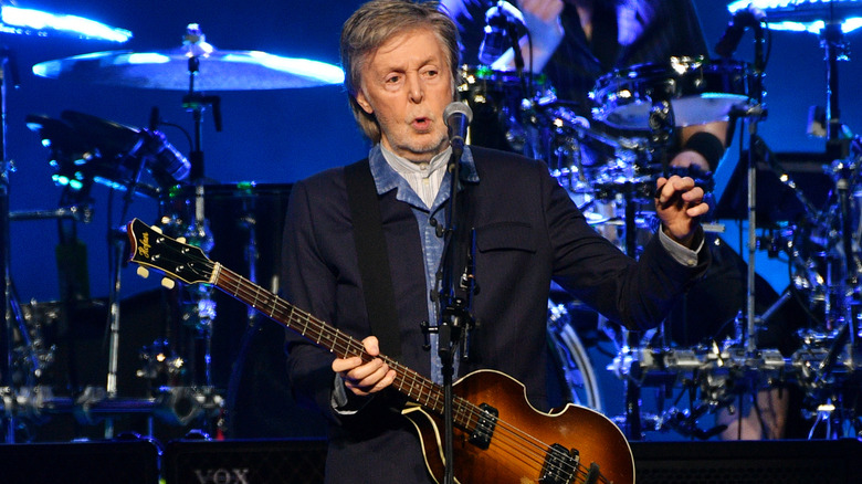 Paul McCartney holding a guitar.