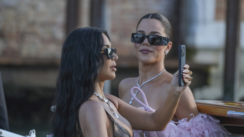 Kim and Khloé Kardashian posing for selfies in Venice.
