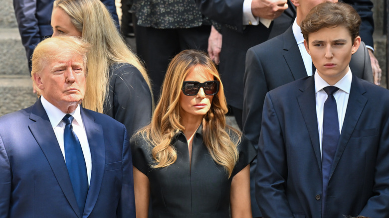 Donald Trump, Melania Trump, and Barron Trump standing