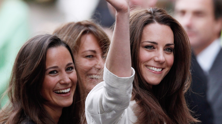 Kate Middleton smiling with Pippa and Carole