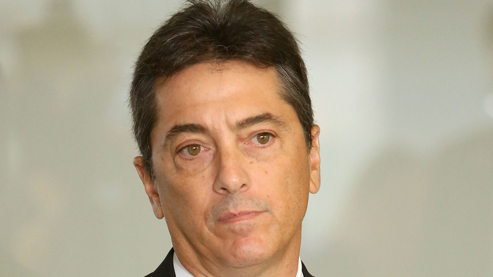 Scott Baio stands at an event 