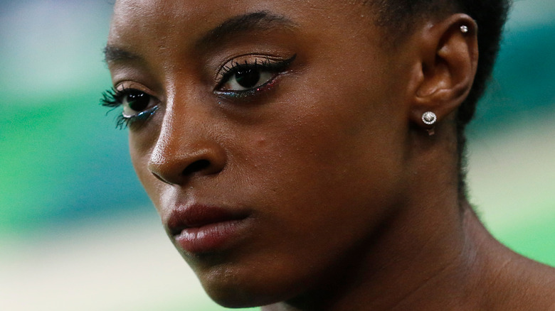 Simone Biles with a serious expression