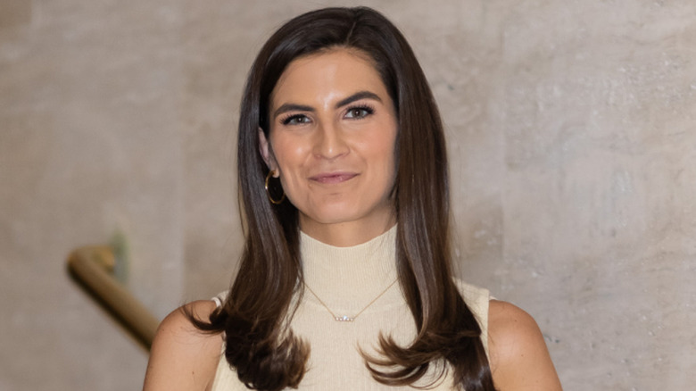 Kaitlan Collins wearing a beige dress