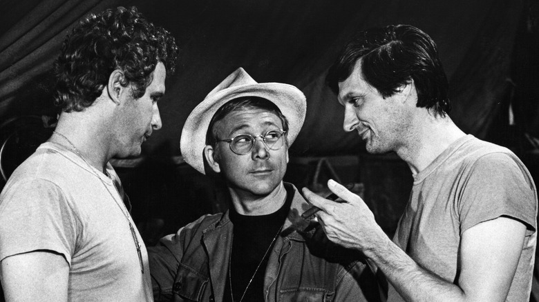 Wayne Rogers as Trapper John, William Christopher as Father Mulcahy, and Alan Alda as Hawkeye in "M*A*S*H."
