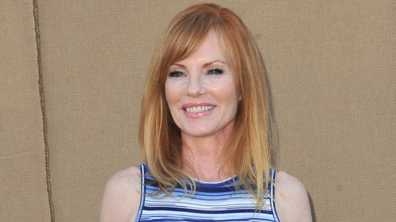 Marg Helgenberger smiling, wearing blue dress