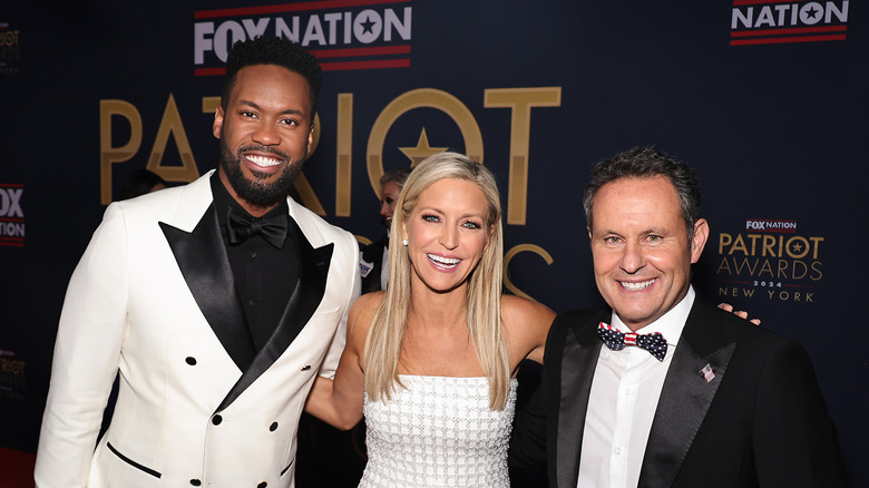 Lawrence Jones, Ainsley Earhardt and Brian Kilmeade pose together