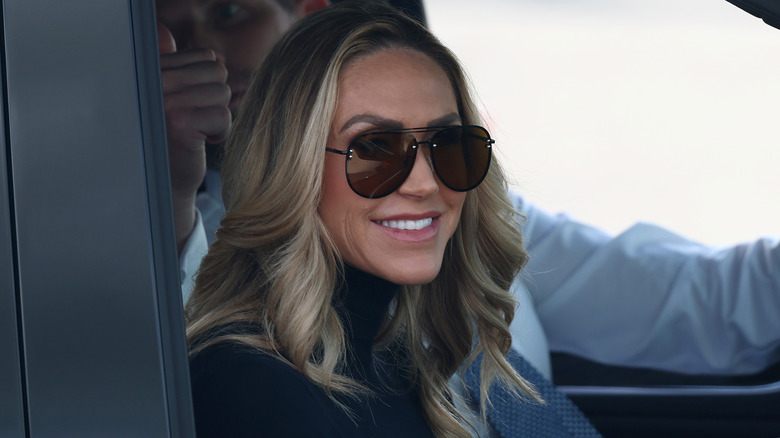 Lara Trump smiles from her car.
