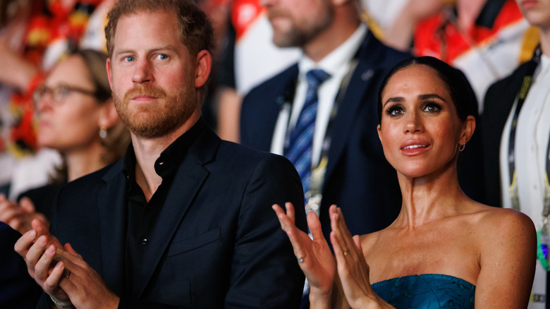 Prince Harry and Meghan Markle clapping