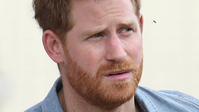 Prince Harry staring with a serious expression