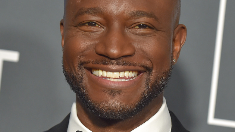 Taye Diggs smiling and looking at camera