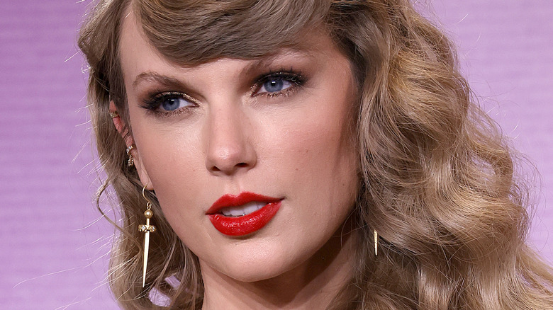 Taylor Swift with red lipstick and wavy hair