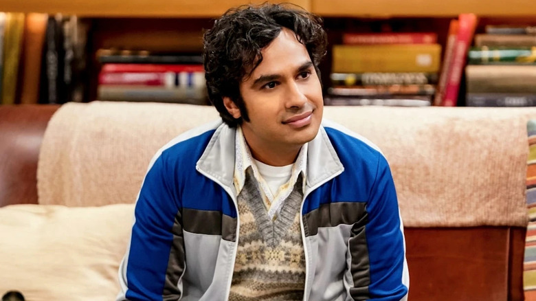Raj sitting on the couch with curly hair on The Big Bang Theory