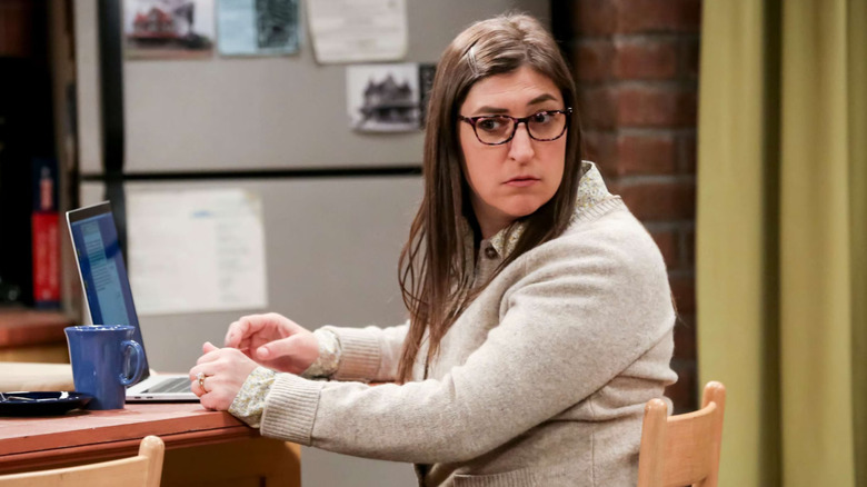 Amy looking over her shoulder while typing on her computer on The Big Bang Theory
