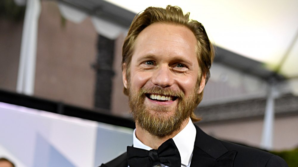 Alexander Skarsgård smiling in a suit