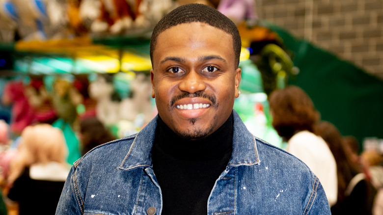 Ross Bagley poses for a photo in a denim jacket