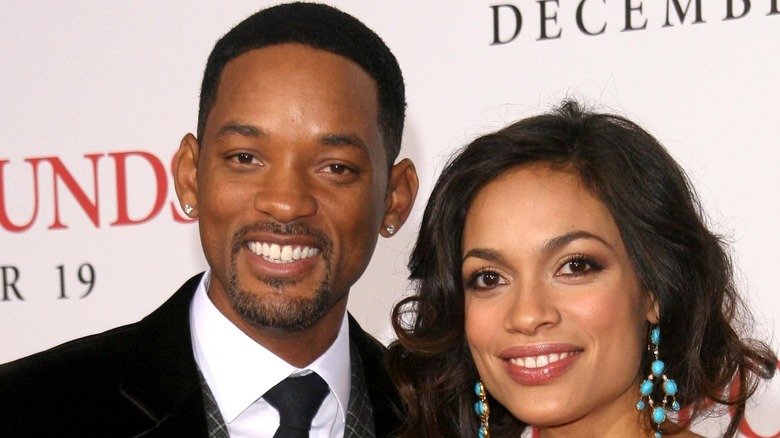 Will Smith and Rosario Dawson smile at a movie premiere