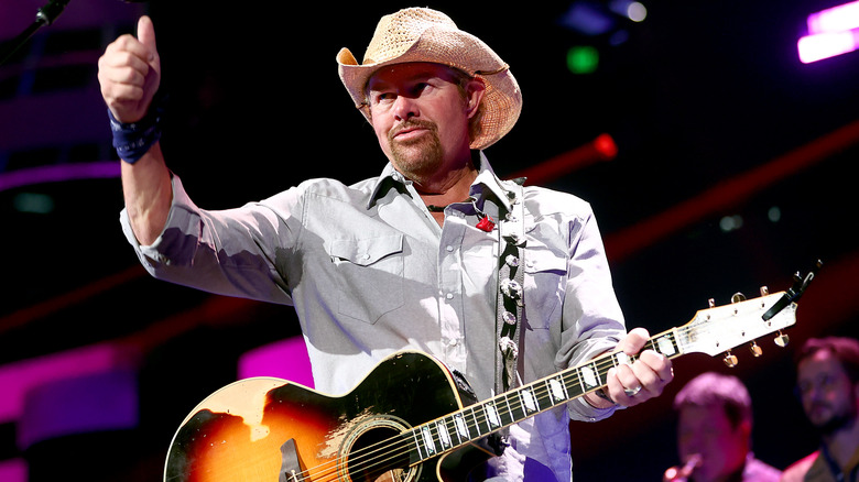 Toby Keith with guitar and hat 