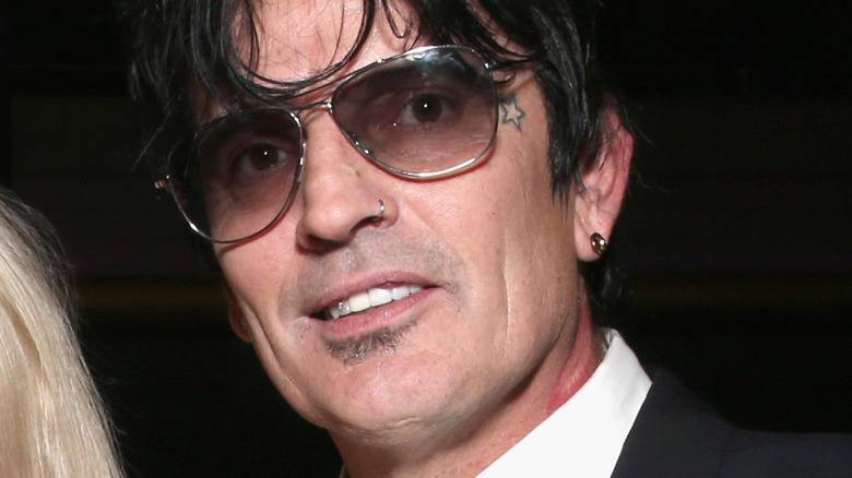 Tommy Lee with sunglasses smiling