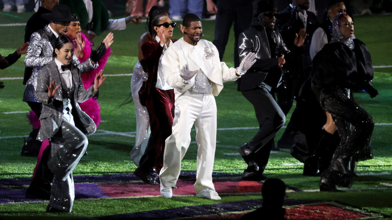 Usher performing with dancers on Super Bowl field