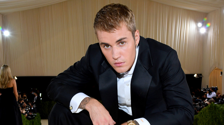Justin Bieber glaring with short hair in tuxedo 