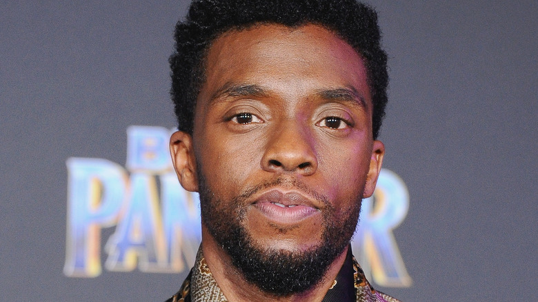 Chadwick Boseman, half smiling, 2018 event photo for "Black Panther' 