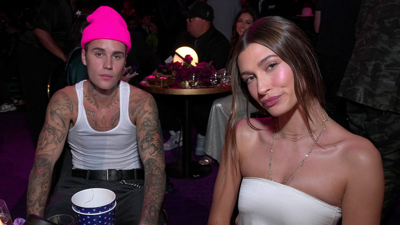 Justin Bieber pink hat, Hailey Bieber white strapless dress