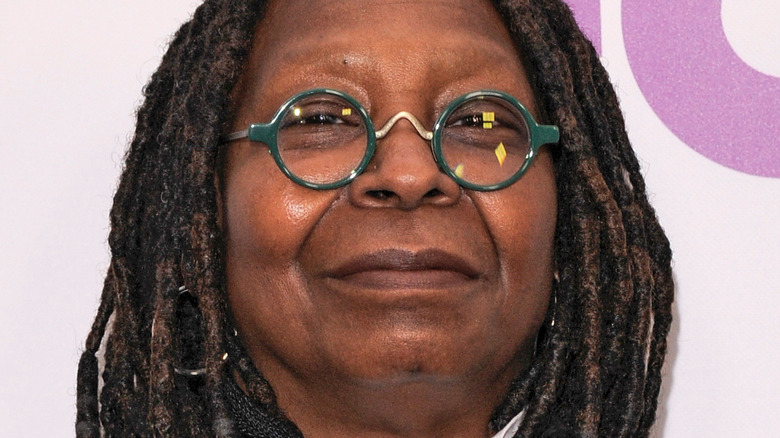 Whoopi goldberg with green glasses on