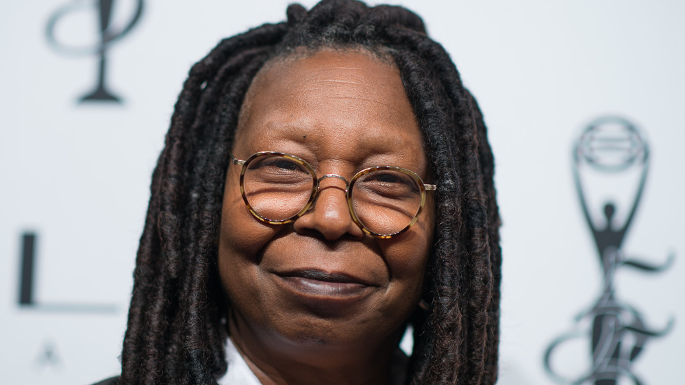 Whoopi Goldberg grins on the red carpet