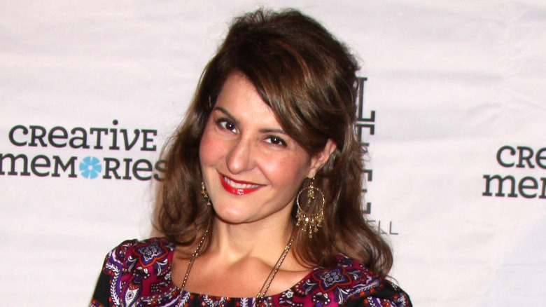 Nia Vardalos smiling and tilting head