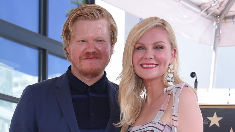 Jesse Plemons and Kirsten Dunst standing smiling
