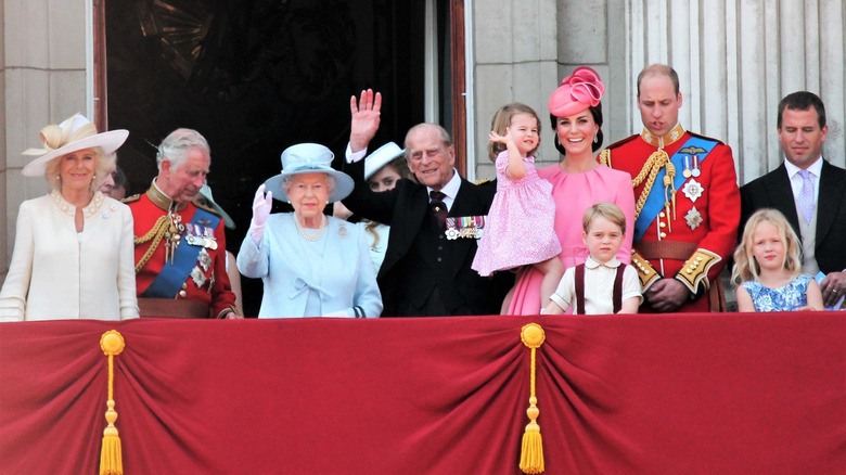 The British Royal Family waving from Buckingham Palace balcony