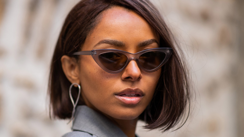 Kat Graham wearing sunglasses during Paris Fashion Week