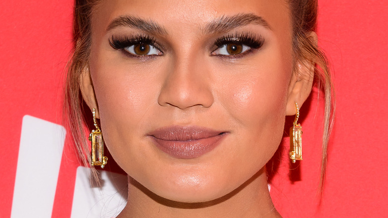 Chrissy Teigen with slight smile on red carpet 