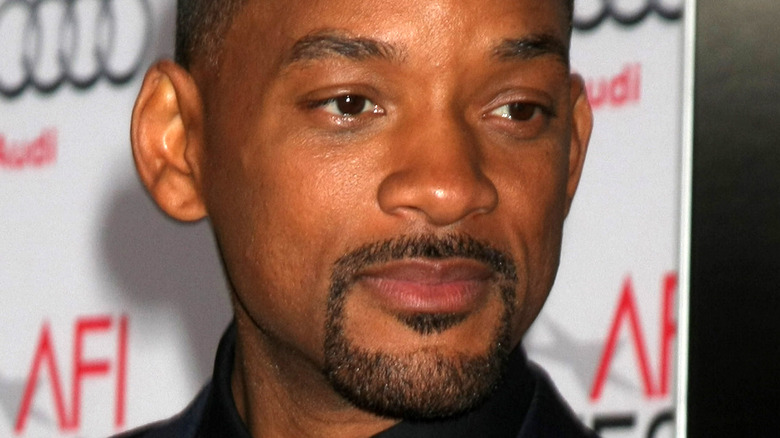 Will Smith grimaces on the AFI red carpet