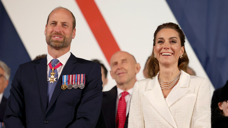 Prince William and Kate Middleton standing apart from each other at an event