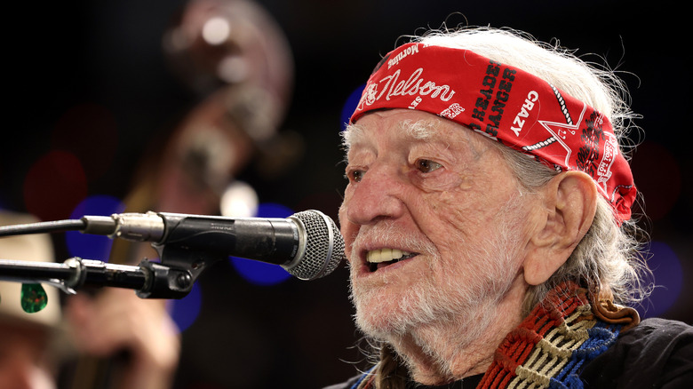 Willie Nelson singing into a microphone