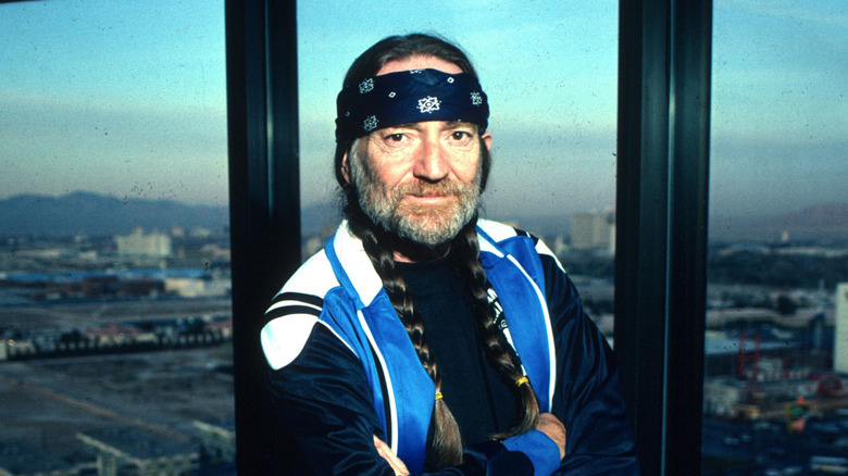 Willie Nelson in the 1980s sporting a blue bandana and outfit