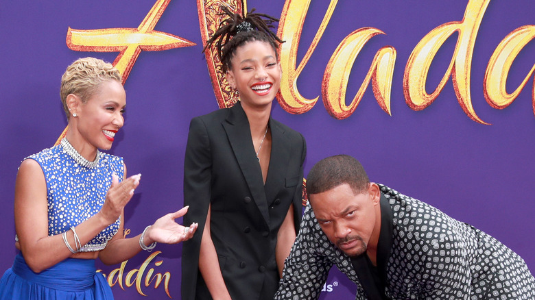 Jada Pinkett, Willow Smith laughing, Will Smith scowling