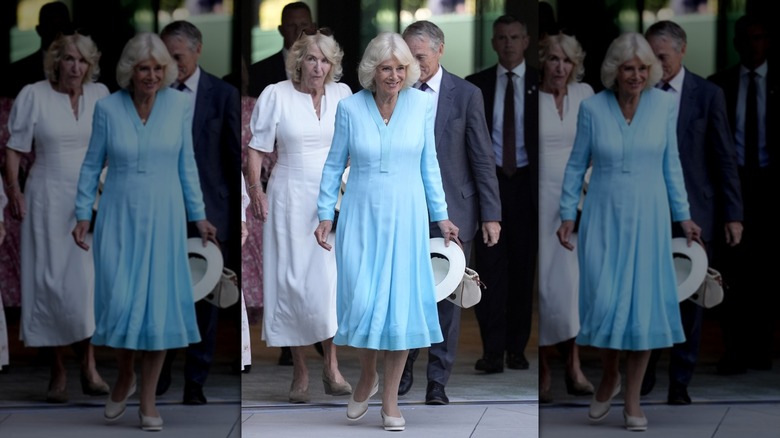Queen Camilla smiling as she walks around Wimbledon.