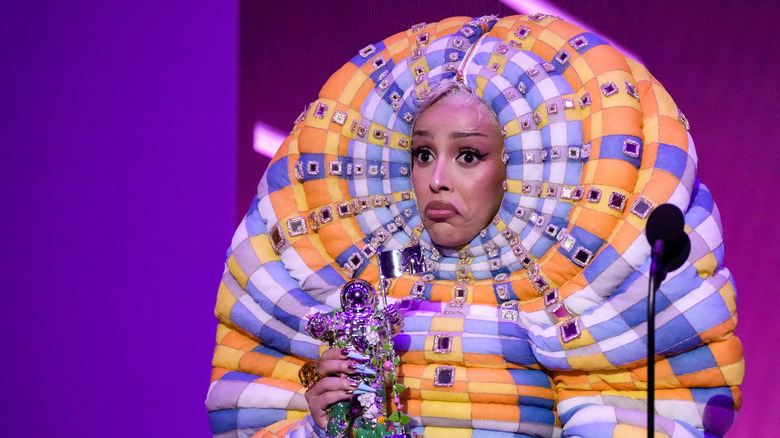 Doja Cat wearing an inflatable hooded gown while holding an MTV Video Music Award.