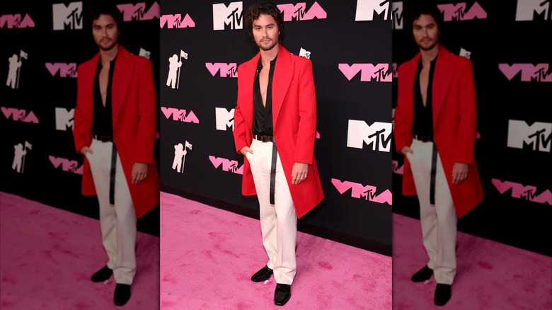 Chase Stokes posing on pink carpet
