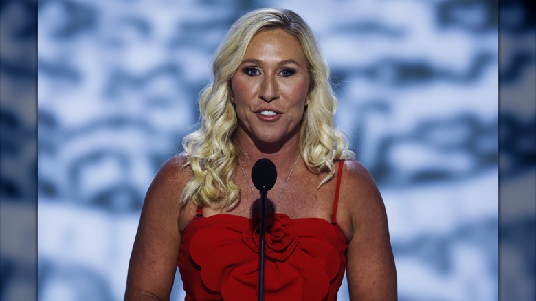 Marjorie Taylor Greene speaking behind microphone