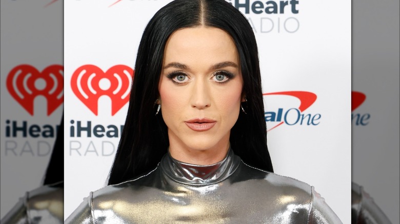 Katy Perry staring into camera in a silver dress