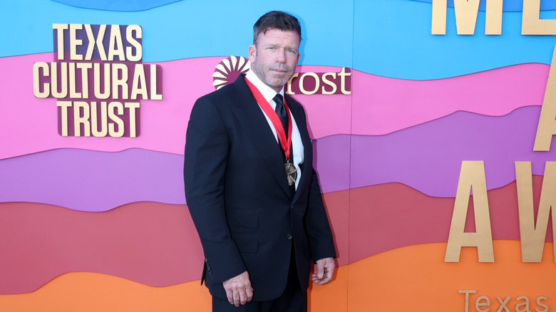 Taylor Sheridan at an event wearing a medal