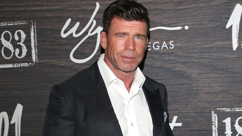 Taylor Sheridan posing in a white shirt and jacket