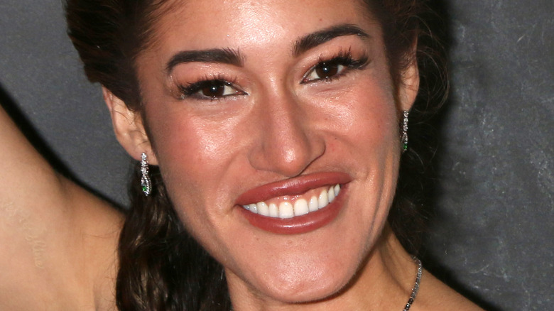 Q'orianka Kilcher smiles, wearing false lashes